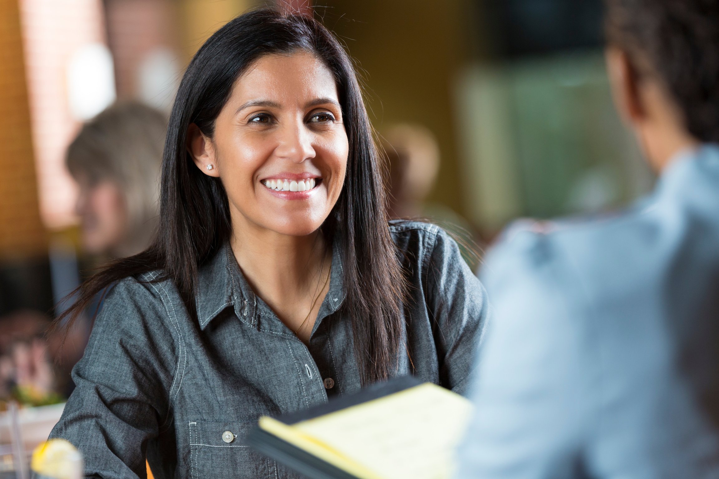 Hispanic woman with resume applying for job during interview meeting